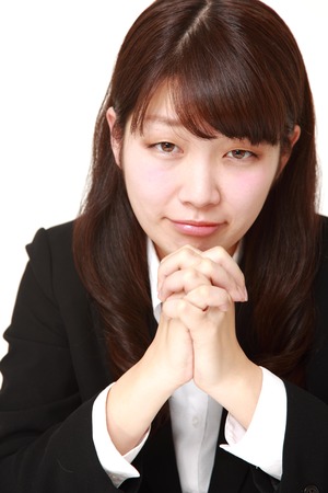 businesswoman folding her hands in prayerの写真素材