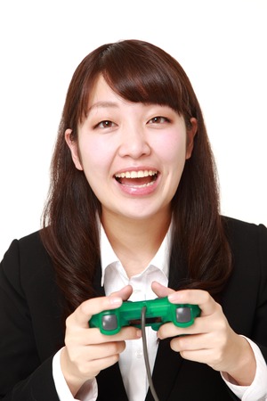 young Japanese businesswoman enjoying a video gameの写真素材