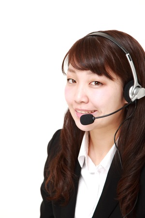 portrait of young Japanese businesswoman of call center smilesの写真素材