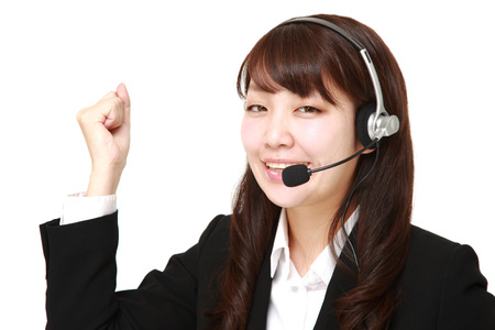 young Japanese businesswoman of call center in a victory poseの写真素材