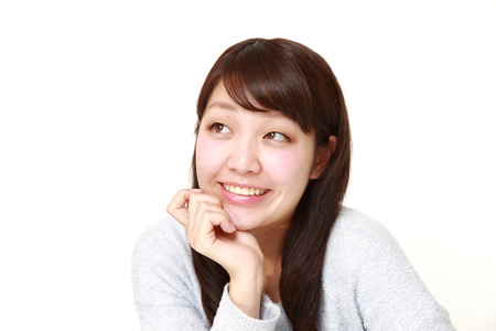 young Japanese woman dreaming at her futureの写真素材