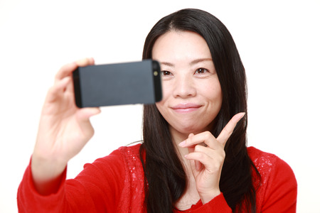 Japanese woman takes a selfieの写真素材