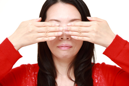 woman covering her face with handsの写真素材