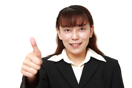 businesswoman with thumbs up gestureの写真素材