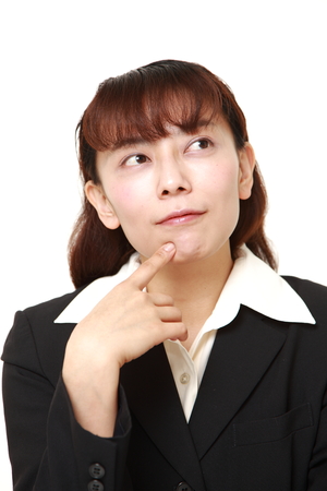 asian businesswoman thinks about somethingの写真素材