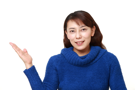 asian woman presenting and showing somethingの写真素材