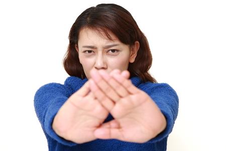asian woman making stop gesture