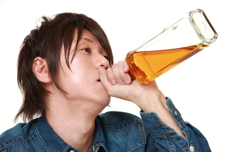 Young Japanese man drunk too muchの写真素材