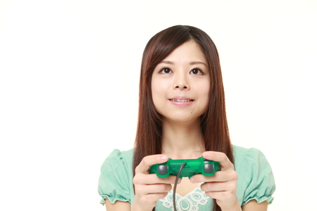 young Japanese woman enjoying a video gameの写真素材