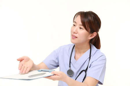 Japanese female doctor with medical interview sheetの写真素材