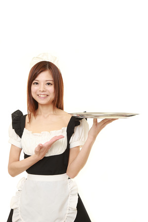 young Japanese woman wearing french maid costume with trayの写真素材