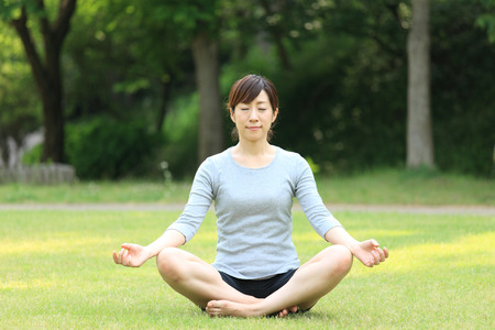 Japanese woman doing meditationの写真素材
