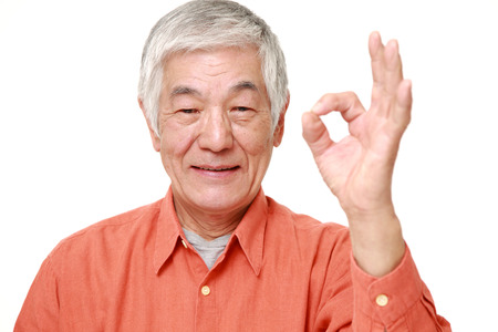 senior Japanese man showing perfect signの写真素材