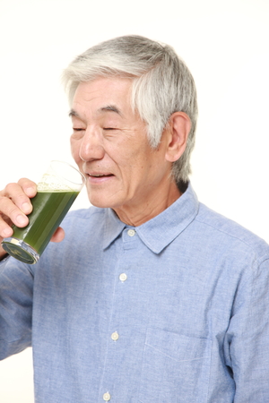 senior Japanese man with green vegetable juiceの写真素材