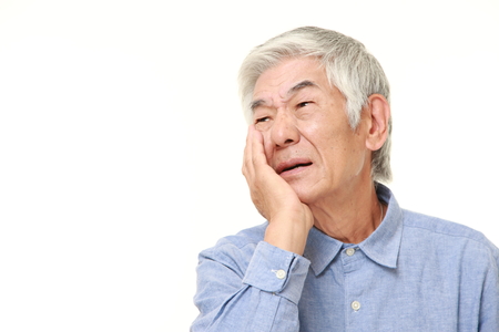 senior Japanese man suffers from toothacheの写真素材
