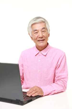 senior Japanese  man using laptop computerの写真素材