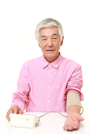 senior Japanese man checking his blood pressureの写真素材