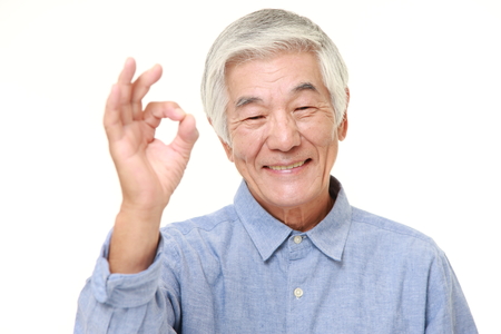 senior Japanese man showing perfect signの写真素材