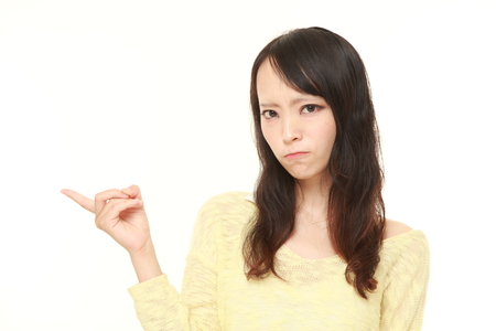 young Japanese woman doubtingの写真素材