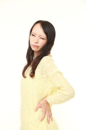 Japanese woman suffers from lumbagoの写真素材
