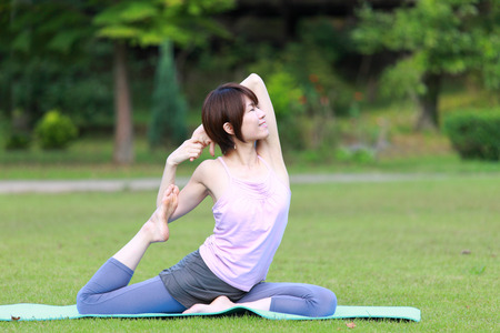 Japanese Woman Doing YOGA "One-Legged King Pigeon Pose"の写真素材