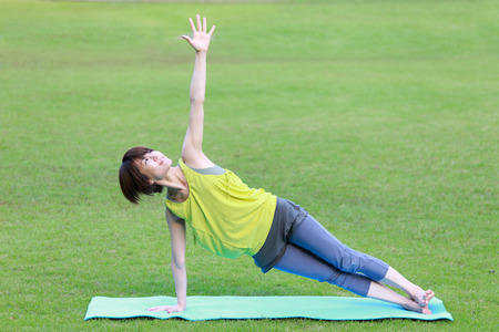 Japanese Woman Doing YOGA "Side Plank pose"の写真素材
