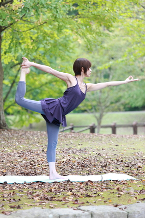 Japanese Woman Doing YOGA "lord of the dance pose"の写真素材