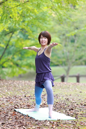 Japanese Woman Doing YOGA "warrior II pose"の写真素材
