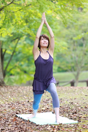 Japanese Woman Doing YOGA "warrior 1 pose"の写真素材