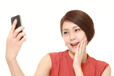 Japanese woman takes a selfieの写真素材