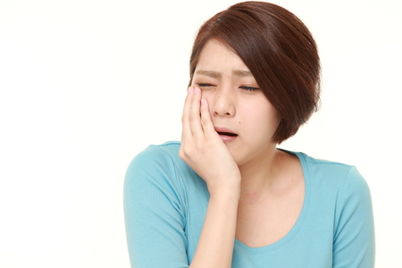 young Japanese woman suffers from toothacheの写真素材