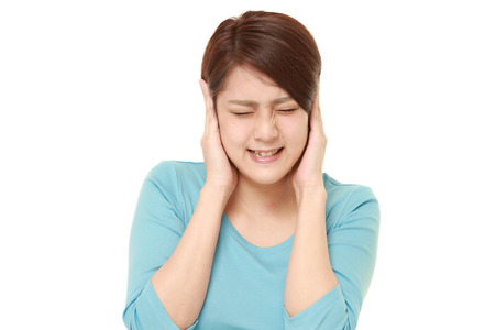 Young Japanese woman suffers from noiseの写真素材