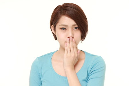 Japanese woman making the speak no evil gestureの写真素材