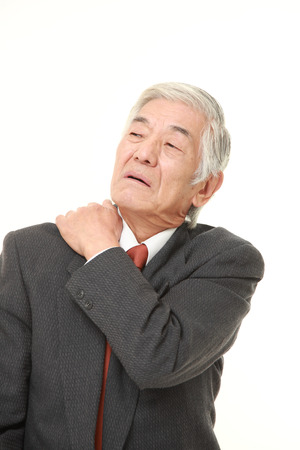 senior Japanese businessman suffers from neck acheの写真素材