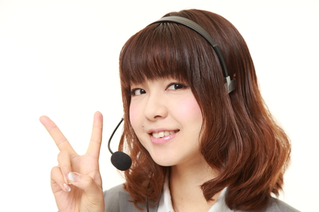 young Japanese Businesswoman showing a victory signの写真素材