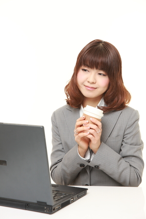 Japanese businesswoman takes a coffee breakの写真素材