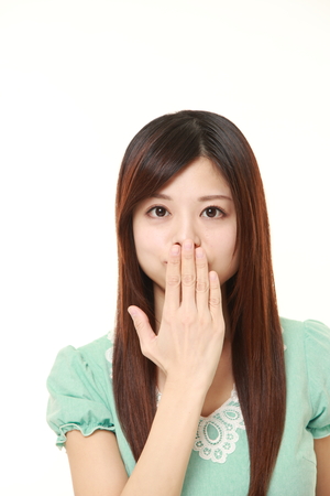 Japanese woman making the speak no evil gestureの写真素材
