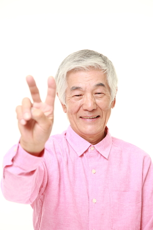 senior Japanese man showing a victory signの写真素材