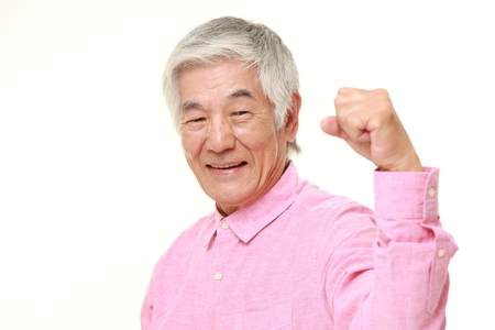 senior Japanese man in a victory poseの写真素材