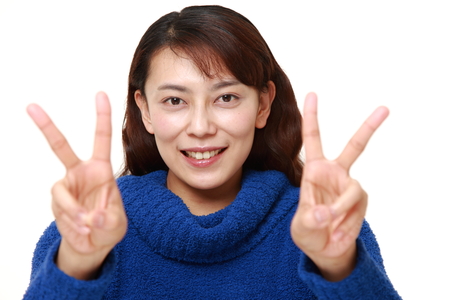 Asian woman showing a victory signの写真素材