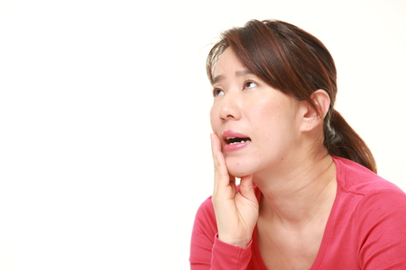 middle aged Japanese woman suffers from toothacheの写真素材