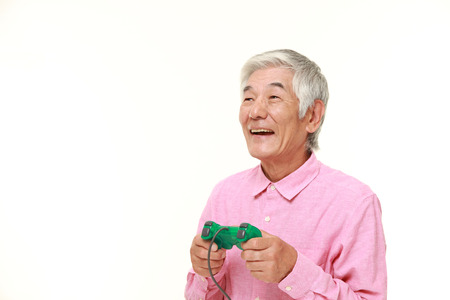 senior Japanese man enjoying a video gameの写真素材