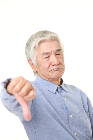 senior Japanese man with thumbs down gestureの写真素材