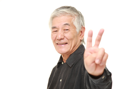 senior Japanese man showing a victory sign