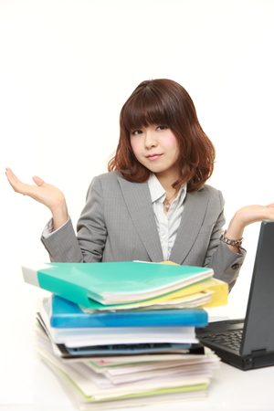 businesswoman shrinks from overtime workの写真素材
