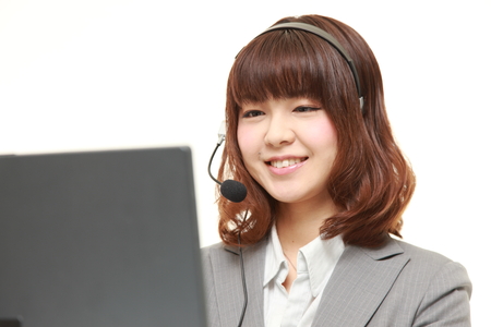 young Japanese businesswoman of call center with head setsの写真素材