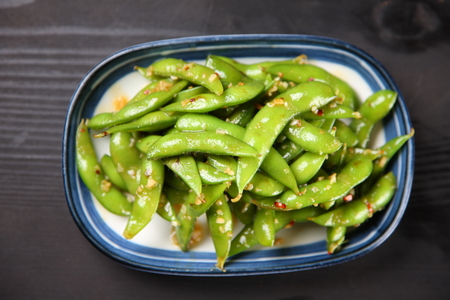Green soybeans with garlic sauceの写真素材