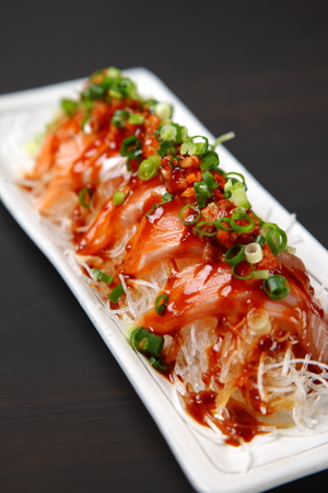 salmon carpaccio in spicy hot sauceの写真素材