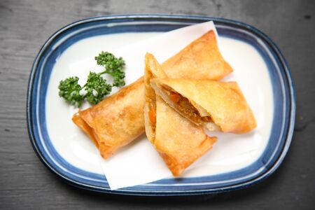 curry flavored spring rolls with parsley