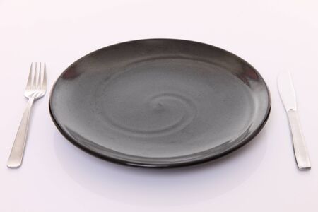 Dish fork and knife on a dining table?の写真素材